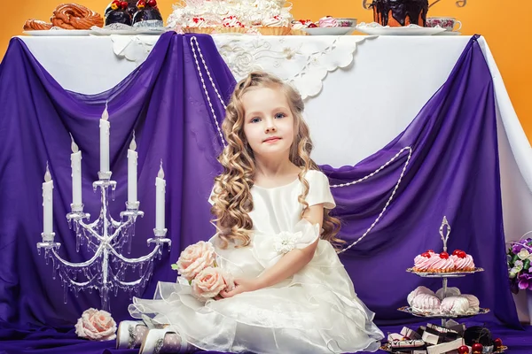 Charming curly girl posing in lush white dress — Stock Photo, Image