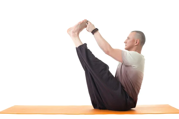 Middle aged man doing yoga in studio. Side view. — Stock Photo, Image