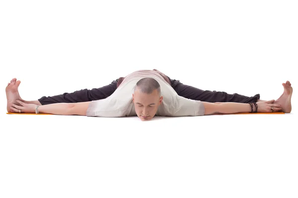 Yogi posing on split, isolated over white backdrop — Stock Photo, Image