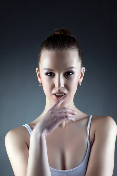 Portrait of pretty young woman, on gray background — Stock Photo, Image