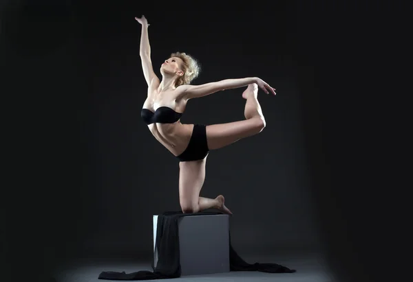 Image of seductive young dancer balancing on cube — Stock Photo, Image