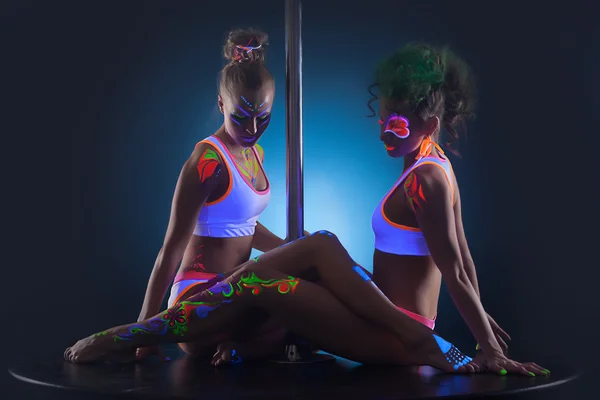 Two modern pole dancers with UV makeup — Stock Photo, Image