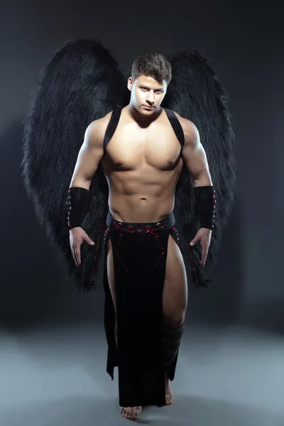 Handsome muscular guy posing as fallen angel — Stock Photo, Image