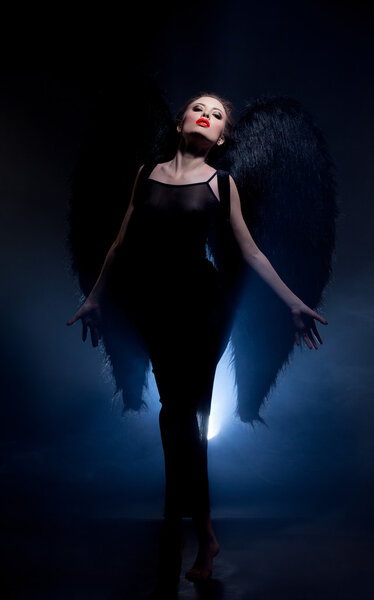 Image of seductive model posing in suit of fallen angel