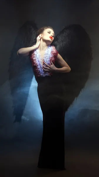 Voluptuous woman posing similitude of fallen angel — Stock Photo, Image