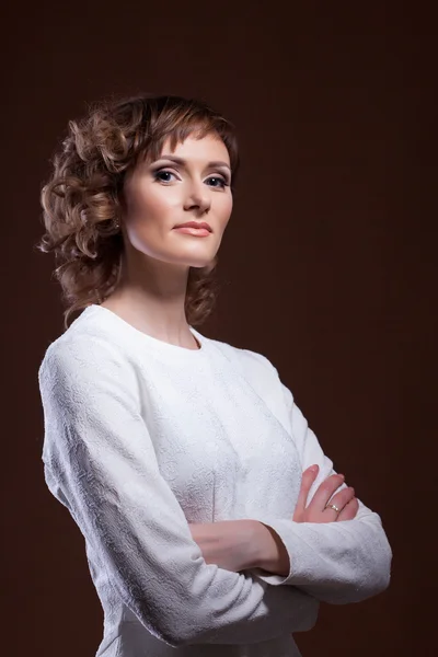 Beautiful middle-aged model posing in white blouse — Stock Photo, Image