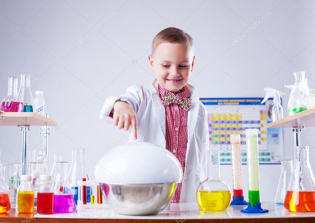 Adorable little boy watching reaction of reagent