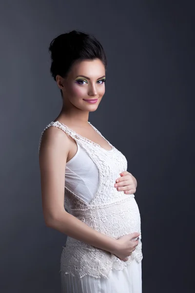 Charming expectant mother posing looking at camera — Stock Photo, Image