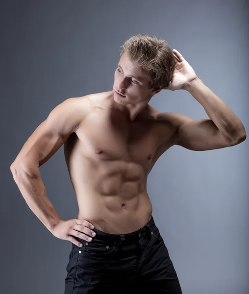 Attractive muscular man posing with naked torso — Stock Photo, Image