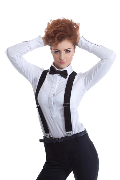 Cute redhead girl posing in suit with suspenders — Stock Photo, Image