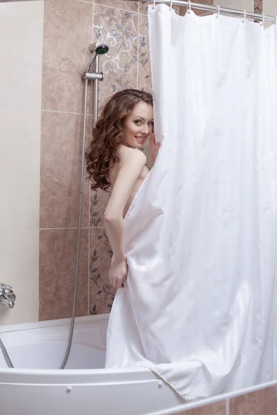 Shy smiling woman posing nude in shower — Stock Photo, Image