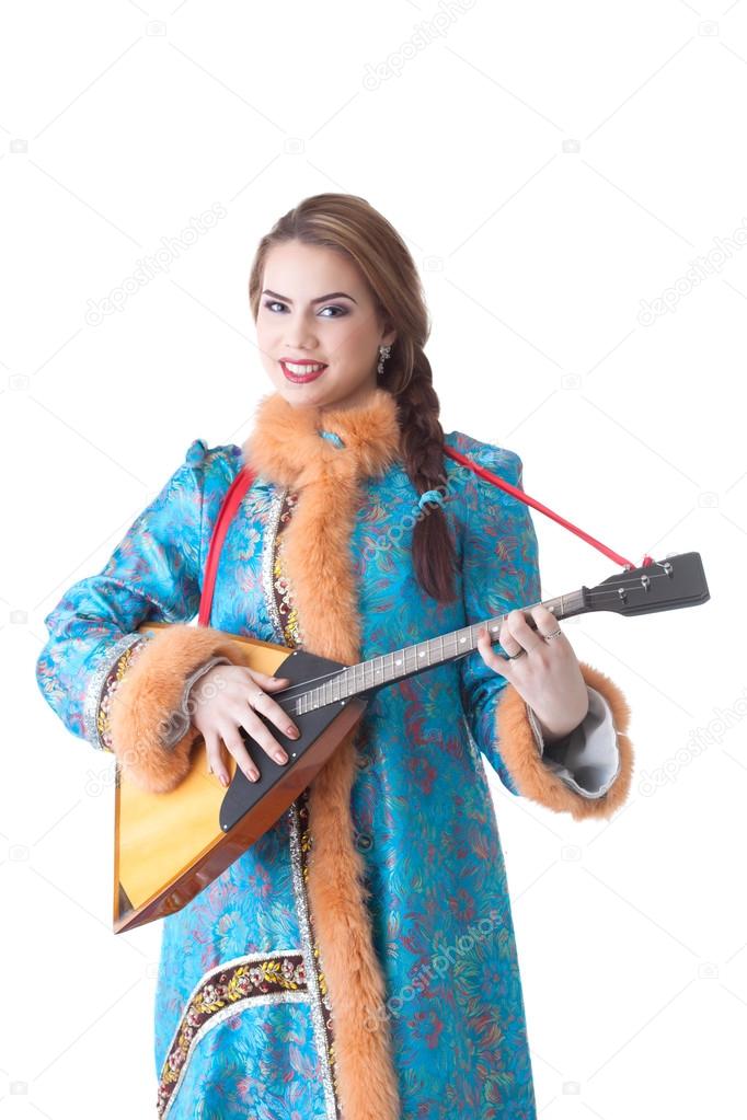 Charming Russian girl playing balalaika in studio