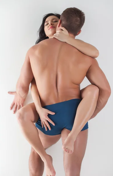 Young brunette crossed her legs on muscular guy — Stock Photo, Image