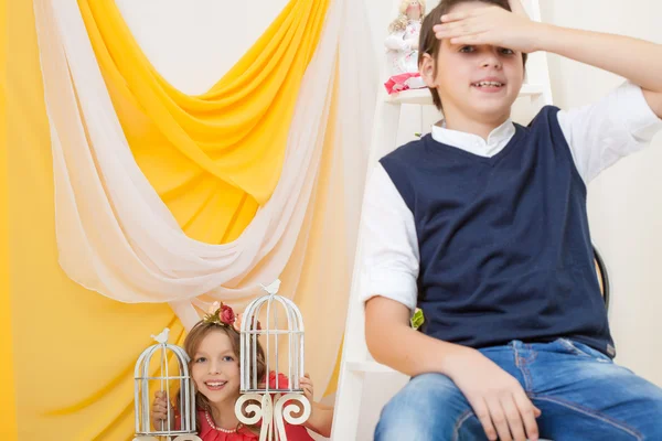 Cute brother and sister posing in vintage interior — Stock Photo, Image