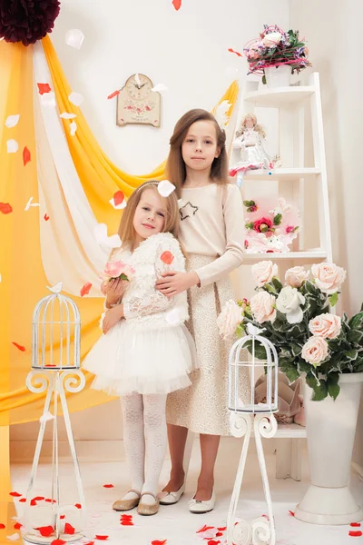 Pretty stylish sisters posing in vintage interior — Stock Photo, Image