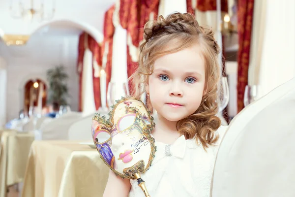 Lovely blue-eyed girl posing with carnival mask — Stock Photo, Image