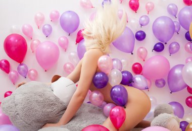 Nude blonde posing with balloons and teddy bear clipart