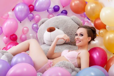 Smiling beautiful model posing with plush bear clipart