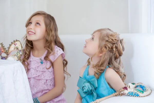 Portrait of smart little girlfriends looking up — Stock Photo, Image