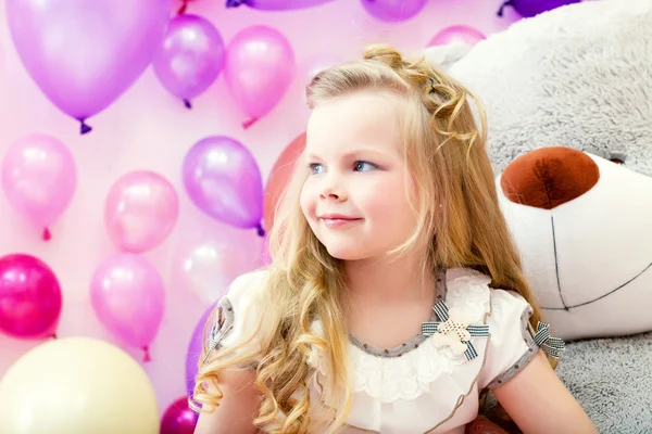 Smiling pretty blonde girl posing in playroom — Stock Photo, Image