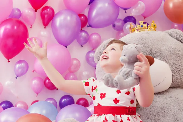 Joyful little girl playing with teddy bears — Stock Photo, Image