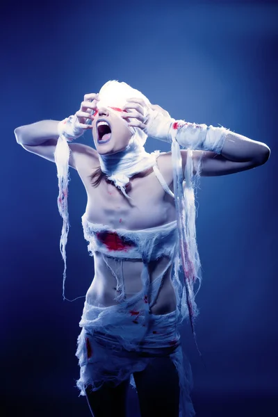 Portrait of screaming mummy pulling her bandages — Stock Photo, Image