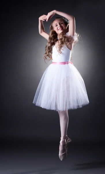 Emotional young ballet dancer posing in jump — Stock Photo, Image