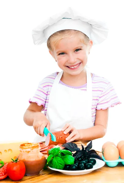Little girl cuting sausage — Stok fotoğraf