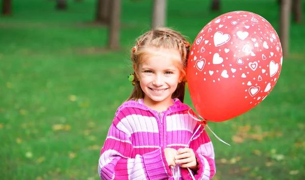 Liten flicka med röd ballong — Stockfoto