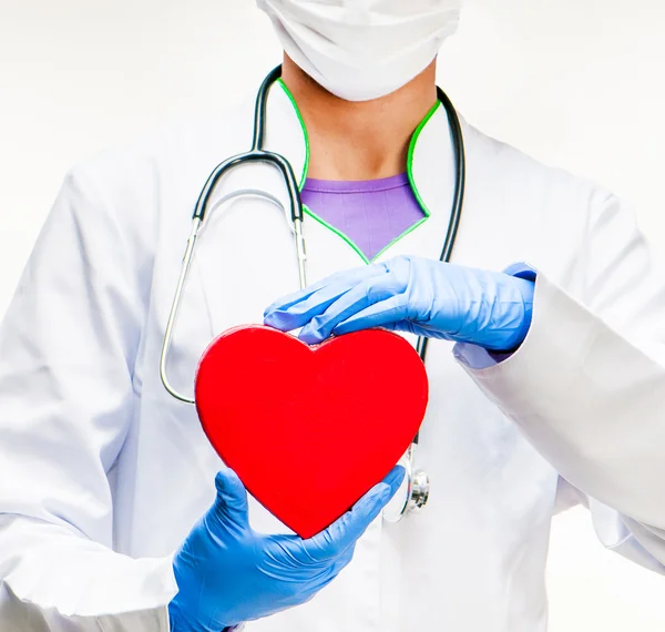 Doctor holding red heart — Stock Photo, Image