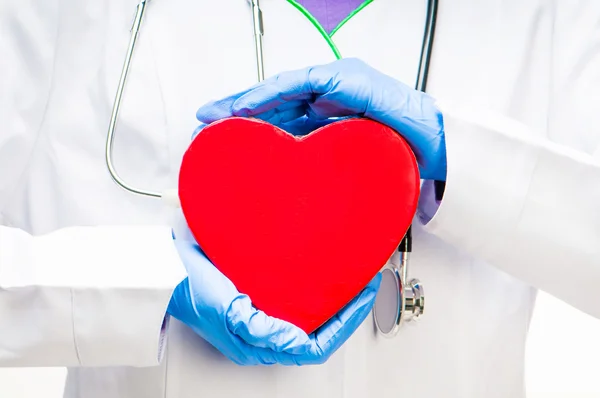 Doctor holding red heart — Stock Photo, Image