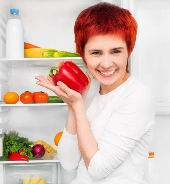 Frau gegen den Kühlschrank — Stockfoto