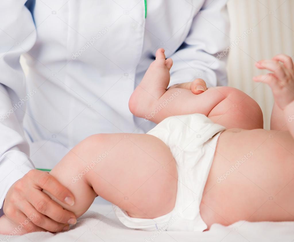 mother massaging baby