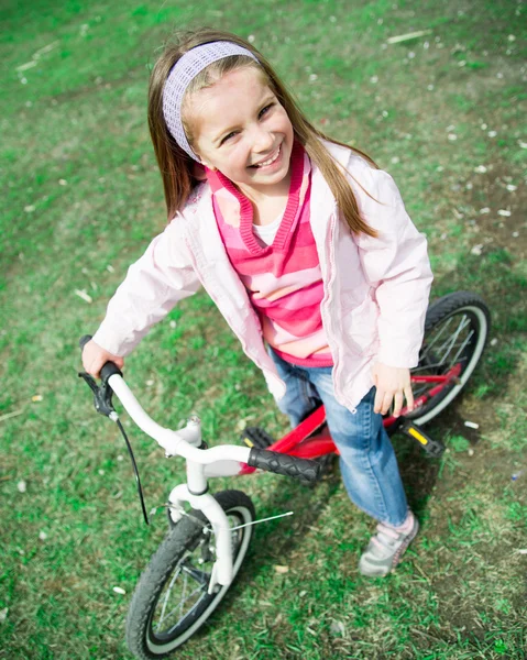 Little girl with her bicycle — Stock Photo, Image