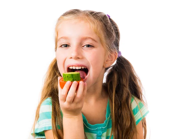 Little girl with cucumbers and tomatoes — Stock Photo, Image