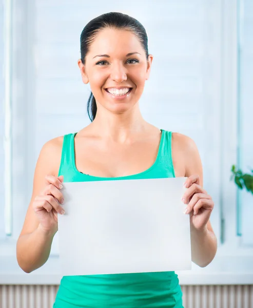 Young woman holding a blank — Stock Photo, Image