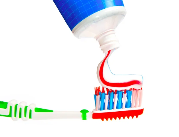 Toothpaste being squeezed onto toothbrush — Stock Photo, Image