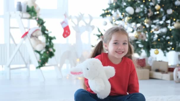 Child girl makes puppet show in Christmas