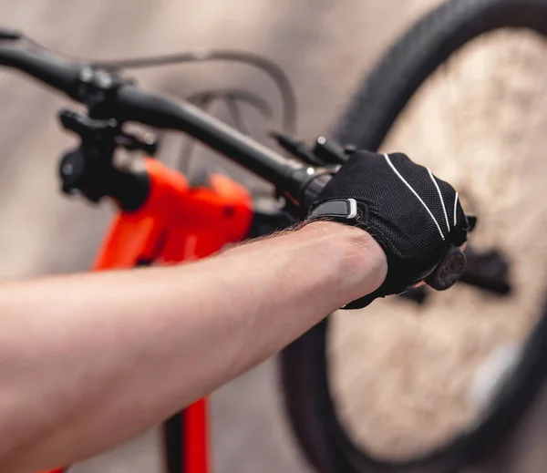 Hand in sport glove on handlebar — Stock Photo, Image