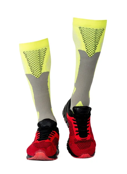 Yellow gaiters in red sneakers — Stock Photo, Image