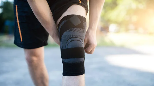 Knee support brace on male legs — Stock Photo, Image