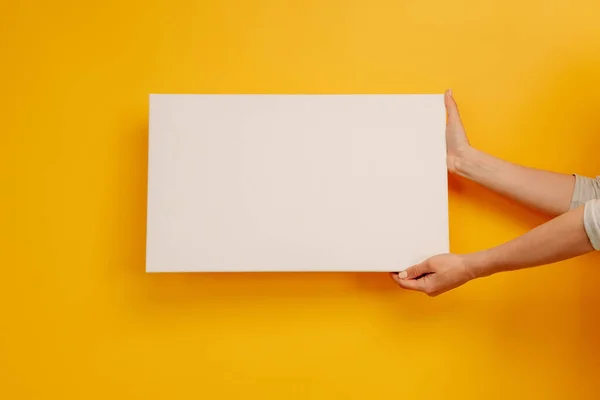 Hand holding white canvas — Stock Photo, Image