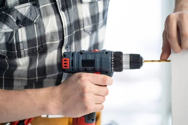 Furniture master drilling chipboard with drill — Stock Photo, Image