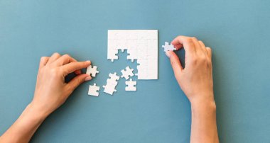 Hands with Small white square puzzle