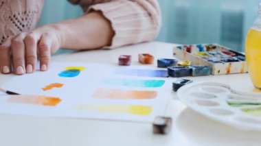Woman making exercises in watercolor