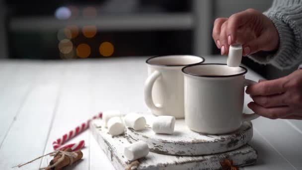 Mujer lanzando malvavisco en taza de cacao — Vídeo de stock