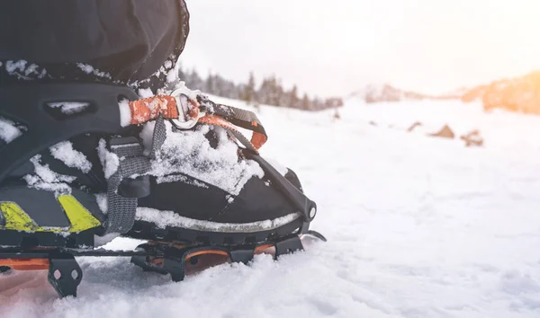 Foot with crampon standing on snow — Stock Photo, Image