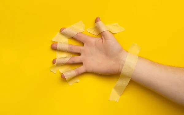 Hand Sealed Masking Tape Isolated Yellow Background Copy Space Concept — Stockfoto