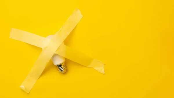 Lamp Sticked Masking Tape Isolated Yellow Background Copy Space Concept — Stockfoto