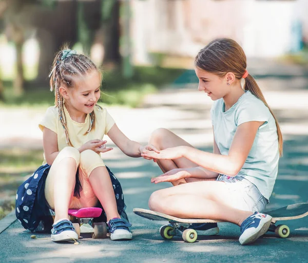 Smiling Little Kids Girls Sitting Skateboards Park Showing Manicure — ストック写真